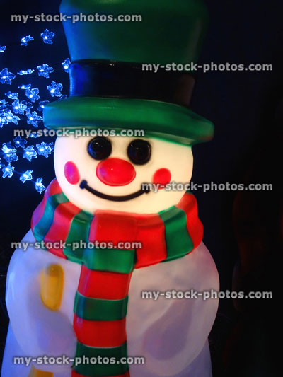 Stock image of large illuminated cuddly life size cartoon Christmas snowman, plastic light, winter display, fairy lights