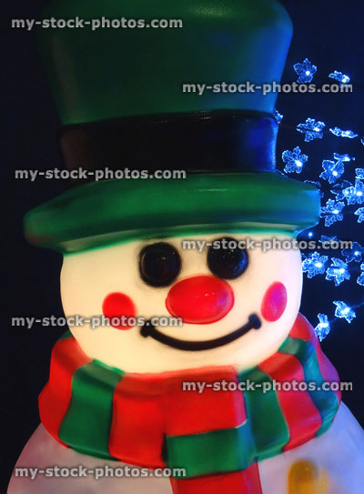 Stock image of large illuminated cuddly life size cartoon Christmas snowman, plastic light, winter display, fairy lights