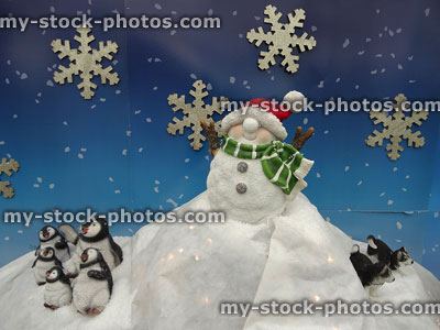Stock image of Christmas display of snowman toy, penguins and husky dogs