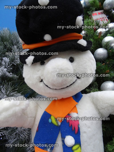 Stock image of large cuddly lifesize cartoon snowman, seasonal winter Christmas display, snow