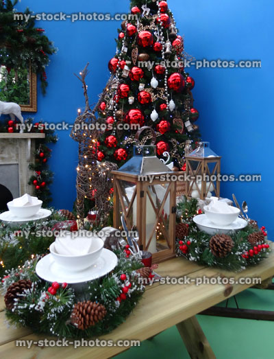 Stock image of Christmas table laid for dinner with decorations / wreaths