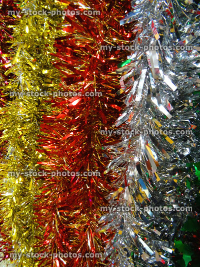 Stock image of coloured tinsel Christmas decorations, red, silver, white, gold