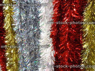 Stock image of coloured tinsel Christmas decorations, red, silver, white, gold