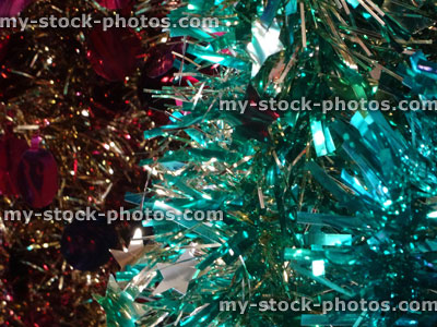 Stock image of coloured tinsel Christmas decorations, red, silver, turqoise blue