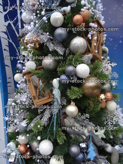 Stock image of artificial Christmas tree, decorations, fairy lights, tinsel, glitter baubles
