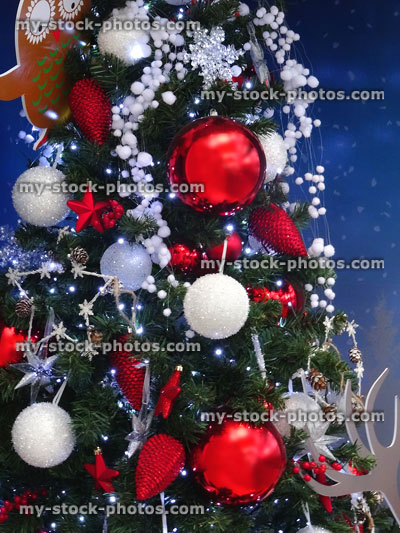 Stock image of artificial Christmas tree, red / white decorations, silver baubles