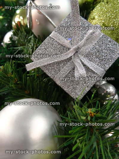 Stock image of artificial Christmas tree with parcels, baubles and decorations