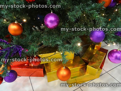 Stock image of Christmas tree with baubles, decorations, fairylights and presents