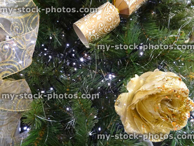 Stock image of Christmas tree decorations, baubles, ribbons, xmas crackers, golden roses, ribbons, fairy lights