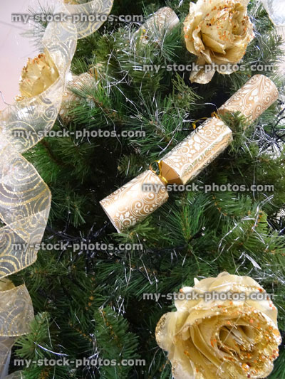 Stock image of Christmas tree decorations, baubles, ribbons, xmas crackers, golden roses, ribbons, fairy lights