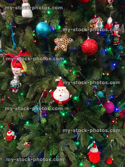 Stock image of artificial Christmas tree, homemade decorations, glitter baubles, Santa Claus, stars, fairy lights