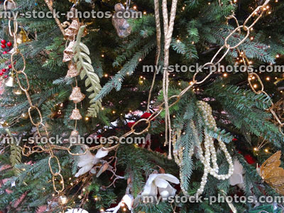 Stock image of artificial Christmas tree, gold / silver decorations, tinsel, chains, garlands, baubles