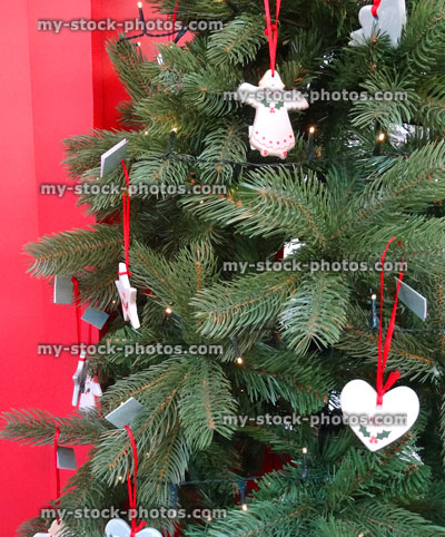 Stock image of artificial Christmas tree decorations, baubles, hanging ornaments, doves, stars, angels, hearts, fairy lights