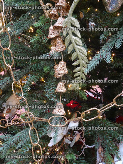 Stock image of artificial Christmas tree, gold / silver decorations, tinsel, chains, garlands, baubles
