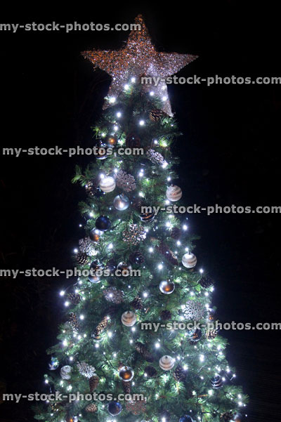 Stock image of Christmas star tree topper decoration night background, bokeh
