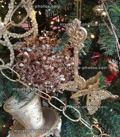 Stock image of artificial Christmas tree, gold and silver decorations, ornaments, tinsel, chain, fairy lights
