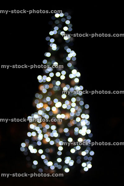 Stock image of defocused Christmas tree white led fairy lights, night background, bokeh