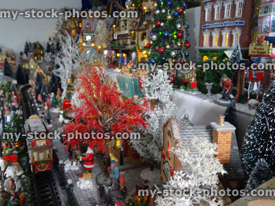 Stock image of model Christmas village with miniature railway, people, winter scene