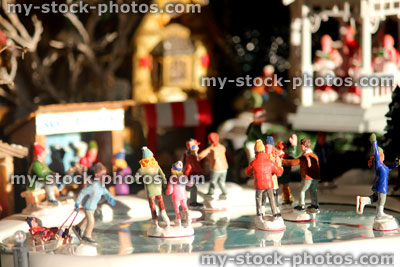 Stock image of model Christmas village with iceskating rink, people, winter scene