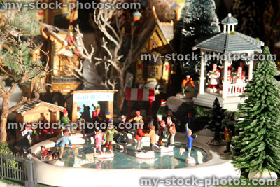 Stock image of model Christmas village with iceskating rink, people, winter scene