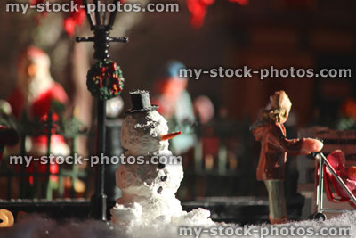 Stock image of model Christmas village with homemade snowman, people, winter scene