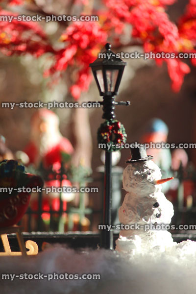 Stock image of model Christmas village with homemade snowman, people, winter scene
