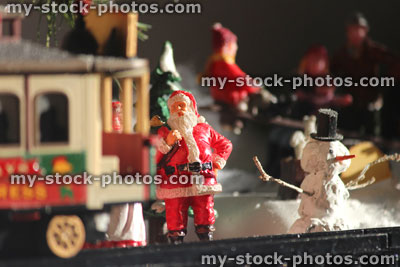Stock image of model Christmas village with Santa, tram, people, winter scene