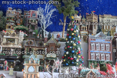 Stock image of model Christmas village with miniature houses, people, winter scene, lights, Christmas tree