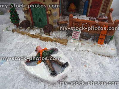 Stock image of model Christmas village , miniature houses, people, snow angel child