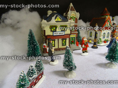 Stock image of model Christmas village with miniature houses, people, pet shop