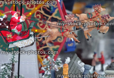 Stock image of Father Christmas / Santa, flying reindeer sleigh over rooftop