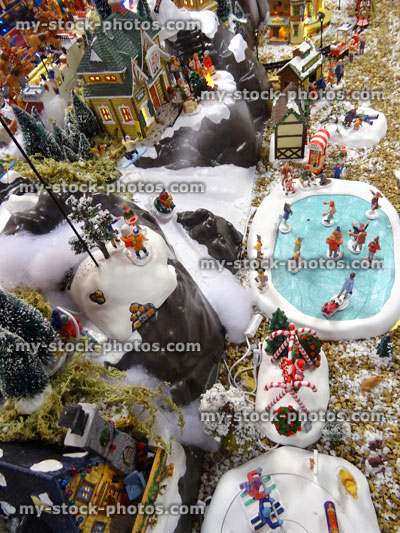 Stock image of model Christmas village with miniature houses, people, ice skating