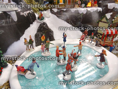 Stock image of model Christmas village with miniature houses, people, ice skating