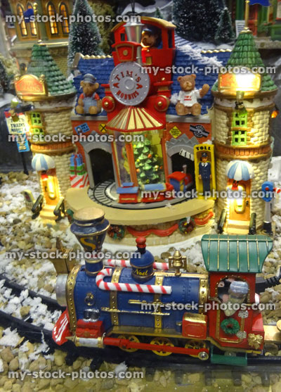 Stock image of model Christmas village with miniature houses, people, train track
