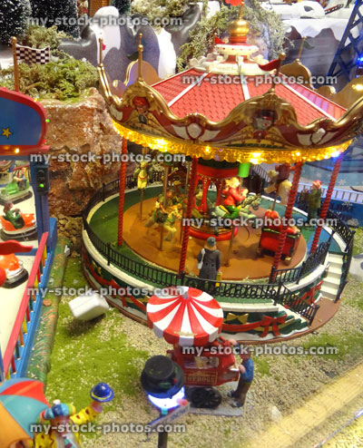 Stock image of model Christmas village with miniature houses, people, carnival rides