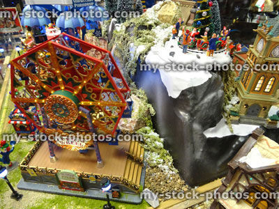 Stock image of model Christmas village with miniature houses, people, Ferris Wheel
