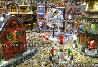 Stock image of model Christmas village with miniature houses, people, Santa