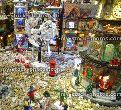 Stock image of model Christmas village with miniature houses, people, Santa