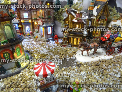 Stock image of model Christmas village with miniature houses, people, horse cart