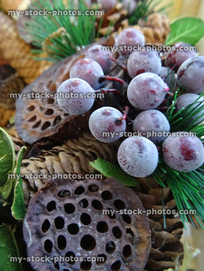 Stock image of dried Christmas wreath, pine cones, lotus pods, spruce needles, berries / grapes