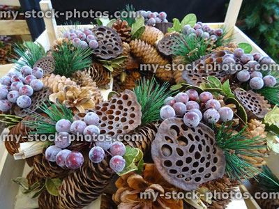 Stock image of dried Christmas wreath, pine cones, lotus pods, spruce needles, berries / grapes