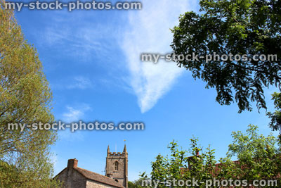 Stock image of historic church steeple, trees and summer blue sky