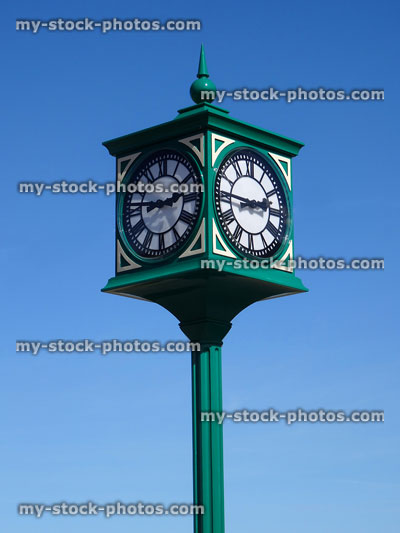 Stock image of metal Victorian clock tower painted-green with Roman numerals
