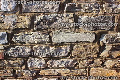 Stock image of repointed cobblestone wall, exterior of old house / stone cottage