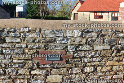 Stock image of re pointed cobblestone stone wall with recessed light, barn conversion house