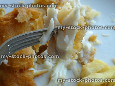 Stock image of takeaway cod and chips being eaten with fork