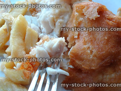 Stock image of unhealthy battered cod / eating takeaway fish and chips