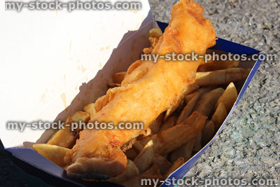 Stock image of battered fish and chips in takeaway card box