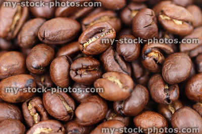 Stock image of roasted coffee beans pile, ready to be ground