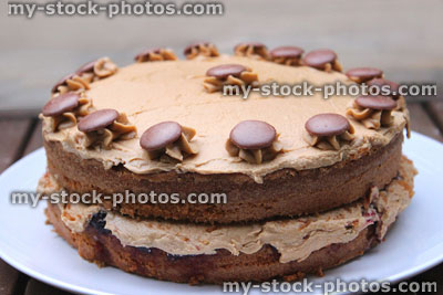 Stock image of homemade chocolate cake decorated with cream / chocolate buttons